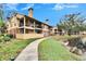 Walkway alongside pond, showcasing building exteriors and landscaping at 8647 Fancy Finch Dr # 203, Tampa, FL 33614