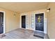 Condo entry with two doors, wood flooring, and a welcome sign at 8647 Fancy Finch Dr # 203, Tampa, FL 33614