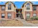 Attractive two-story condo building with brick and siding exterior, stairs, and landscaping at 8647 Fancy Finch Dr # 203, Tampa, FL 33614