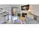 Bright living room features a fireplace, comfy sofa, and access to a balcony at 8647 Fancy Finch Dr # 203, Tampa, FL 33614