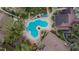 Community pool with surrounding lounge chairs and landscaping at 8647 Fancy Finch Dr # 203, Tampa, FL 33614