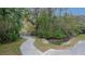 Concrete walkway winds through landscaping toward a tranquil waterway at 8647 Fancy Finch Dr # 203, Tampa, FL 33614