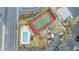 Aerial view showing community pool, tennis court, and parking at 9119 Tudor Dr # E201, Tampa, FL 33615