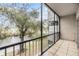 Screened balcony with water view and lush landscape at 9119 Tudor Dr # E201, Tampa, FL 33615