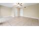Bright bedroom with ceiling fan and tile floors at 9119 Tudor Dr # E201, Tampa, FL 33615