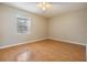 Bright bedroom featuring wood-look floors and a ceiling fan at 9119 Tudor Dr # E201, Tampa, FL 33615