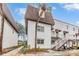 Two-story condo building with a brown roof and white exterior at 9119 Tudor Dr # E201, Tampa, FL 33615