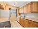 Efficient kitchen, featuring wood cabinets and appliances at 9119 Tudor Dr # E201, Tampa, FL 33615