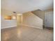 Open living room with tile floors and kitchen access at 9119 Tudor Dr # E201, Tampa, FL 33615