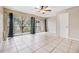 Living room with balcony access and tile floors at 9119 Tudor Dr # E201, Tampa, FL 33615