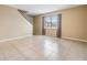 Bright living room featuring tile floors and staircase access at 9119 Tudor Dr # E201, Tampa, FL 33615