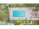 Community pool with surrounding lounge chairs and patio area at 9119 Tudor Dr # E201, Tampa, FL 33615