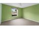 Light green bedroom with window and ceiling fan at 936 Kings Blvd, Sun City Center, FL 33573