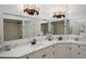 Bathroom boasts a corner double vanity and a large mirror at 110 Deerpath Dr, Oldsmar, FL 34677