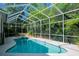 Relaxing screened pool and spa with lush landscaping at 110 Deerpath Dr, Oldsmar, FL 34677