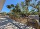 Deck overlooks a fenced backyard with mature trees and a shed at 1116 E Boyer St, Tarpon Springs, FL 34689