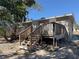 Home features a spacious back deck with wooden railings and stairs at 1116 E Boyer St, Tarpon Springs, FL 34689