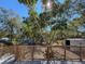 View from deck showcases a spacious backyard with lush trees and a shed at 1116 E Boyer St, Tarpon Springs, FL 34689
