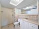 Bathroom with shower, toilet, vanity, and updated tile at 1116 E Boyer St, Tarpon Springs, FL 34689