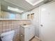 Clean bathroom with toilet, vanity and large mirror at 1116 E Boyer St, Tarpon Springs, FL 34689