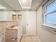 Bright bathroom with vanity, toilet and access to other rooms at 1116 E Boyer St, Tarpon Springs, FL 34689
