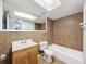 Clean bathroom with tub, toilet, and vanity at 1116 E Boyer St, Tarpon Springs, FL 34689