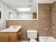 Updated bathroom with a shower/tub combo, vanity, and tile flooring at 1116 E Boyer St, Tarpon Springs, FL 34689