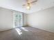 Bright bedroom with ceiling fan and access to balcony at 1116 E Boyer St, Tarpon Springs, FL 34689