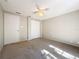 Bedroom with ceiling fan and double door closet at 1116 E Boyer St, Tarpon Springs, FL 34689