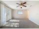 Spacious bedroom with carpet, ceiling fan and access to a deck at 1116 E Boyer St, Tarpon Springs, FL 34689