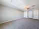 Spacious bedroom with ceiling fan, carpet, and multiple closets at 1116 E Boyer St, Tarpon Springs, FL 34689