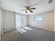 Spacious bedroom with carpet, ceiling fan, and sliding glass doors to deck at 1116 E Boyer St, Tarpon Springs, FL 34689