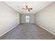 Bright bedroom with ceiling fan, carpet, and a window at 1116 E Boyer St, Tarpon Springs, FL 34689