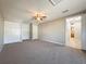 Spacious bedroom with ceiling fan, carpet, and access to bathroom at 1116 E Boyer St, Tarpon Springs, FL 34689