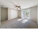 Spacious bedroom with carpet, ceiling fan, and sliding glass doors to deck at 1116 E Boyer St, Tarpon Springs, FL 34689