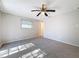 Well-lit bedroom with carpet, ceiling fan and access to a deck at 1116 E Boyer St, Tarpon Springs, FL 34689