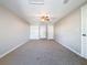 Spacious bedroom with ceiling fan, carpet, and multiple closets at 1116 E Boyer St, Tarpon Springs, FL 34689
