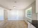 Bright dining area with tile floor and adjacent kitchen at 1116 E Boyer St, Tarpon Springs, FL 34689