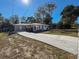 Newly renovated home with a long driveway and mature trees at 1116 E Boyer St, Tarpon Springs, FL 34689