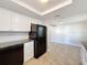 Updated kitchen with white cabinets, granite countertops, and black appliances at 1116 E Boyer St, Tarpon Springs, FL 34689