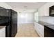 Modern kitchen with black appliances and granite countertops at 1116 E Boyer St, Tarpon Springs, FL 34689