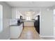 Modern kitchen with white cabinets and black appliances at 1116 E Boyer St, Tarpon Springs, FL 34689