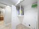 Well-lit laundry room with washer and dryer hookups and shelving at 1116 E Boyer St, Tarpon Springs, FL 34689