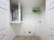 Laundry room featuring a water heater and shelving unit at 1116 E Boyer St, Tarpon Springs, FL 34689