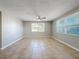 Bright and airy living room with tile flooring and large windows at 1116 E Boyer St, Tarpon Springs, FL 34689