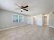 Bright living room features tile flooring and ceiling fan at 1116 E Boyer St, Tarpon Springs, FL 34689