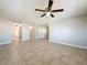Large living area with tile floors and neutral walls at 1116 E Boyer St, Tarpon Springs, FL 34689