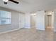 Open living room with tile floors and access to hallway at 1116 E Boyer St, Tarpon Springs, FL 34689