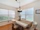 Bright dining room with white table, chandelier, and large windows at 11616 Crest Creek Dr, Riverview, FL 33569