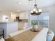 Bright dining room with white table, chandelier, and large windows at 11616 Crest Creek Dr, Riverview, FL 33569